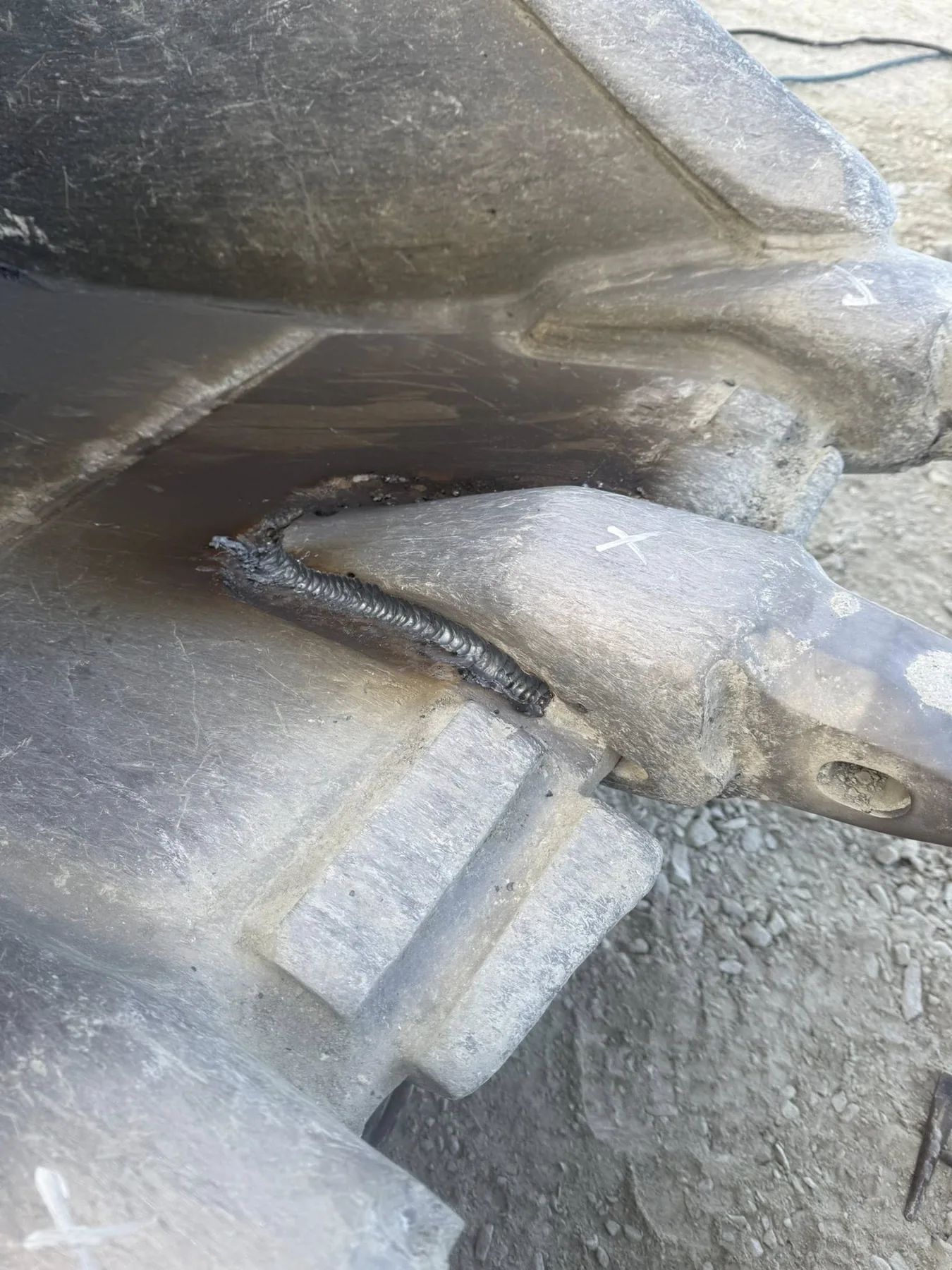 Close-up welded repair on bucket