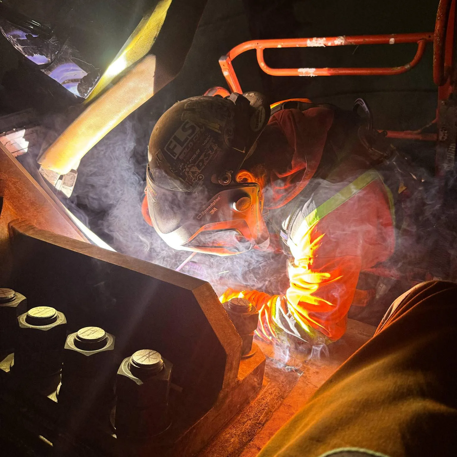 Welder working with smoke and sparks